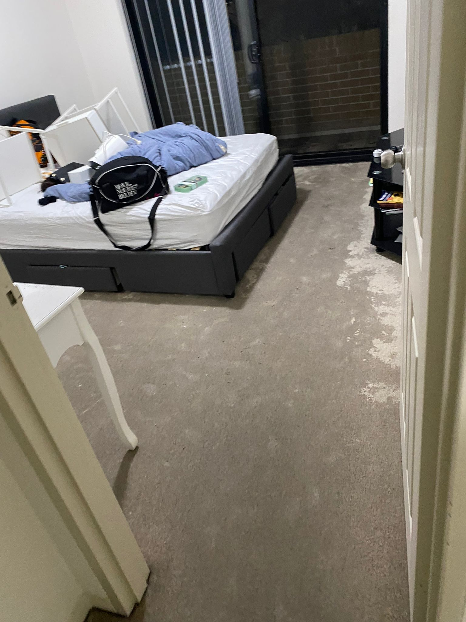 Bedroom with wet carpet before extraction